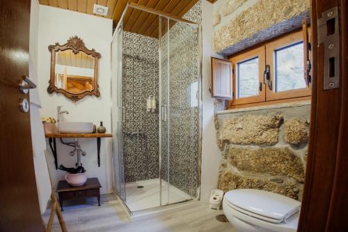 a bathroom with a shower with a toilet and a sink at Refúgios da Natureza in Entre-os-Rios