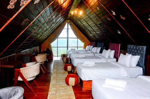 a room with a bunch of beds in a attic at The Rusty Villa in Hatton