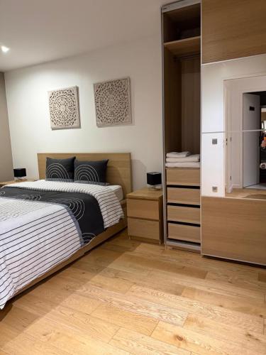 a bedroom with two beds and two dressers at Appartement duplex T3 avec box - Paris - La Défense - Airport CDG - Parc des expositions - Stade de France - Disney - Astérix - Val D Europe in Villepinte