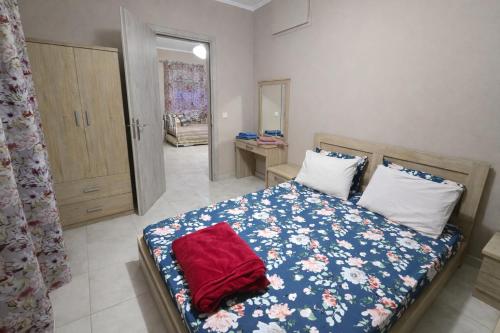 a bedroom with a bed with a red pillow on it at Vasilikis Place in Elafonisos