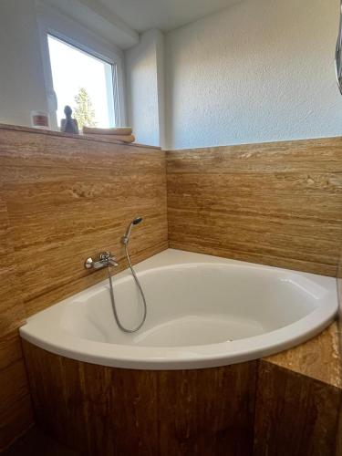 a bath tub with a faucet in a bathroom at Hochsitz Appartement in Seelitz