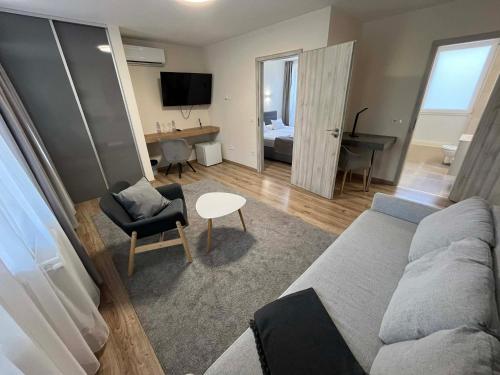 a living room with a couch and a table at Brill Hotel Békéscsaba in Békéscsaba