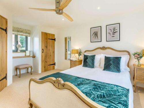 a bedroom with a large bed and a ceiling fan at 2 Bed in Newton Tracey oc-80381 in Bishops Tawton