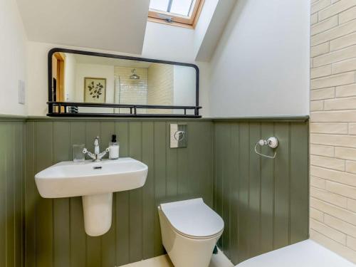 a bathroom with a sink and a toilet and a mirror at 2 Bed in Newton Tracey oc-80381 in Bishops Tawton