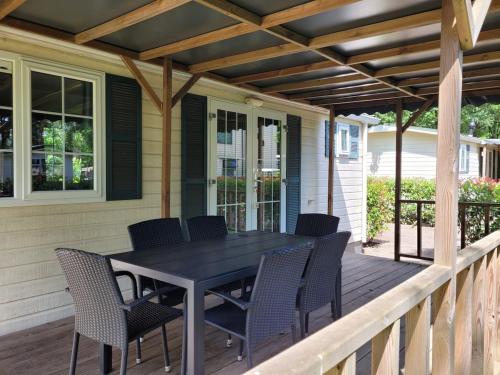 a patio with a table and chairs on a deck at Chalet Spring voor 6 personen I Resort de Heimolen in Baarle-Nassau