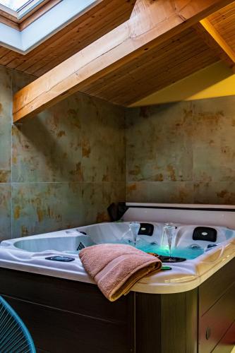 a bathroom with a tub with a towel on it at Chambre Terracotta privée et accès jacuzzi - sauna in Lézat-sur-Lèze