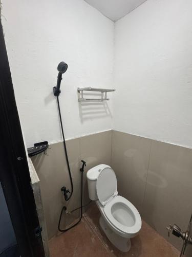 a bathroom with a toilet with a camera on the wall at Evas Inn in General Santos