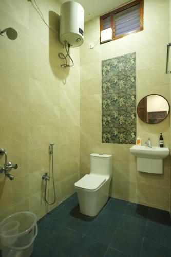 a bathroom with a toilet and a sink at Desert Beach House with swimming pool in Kuilapayam