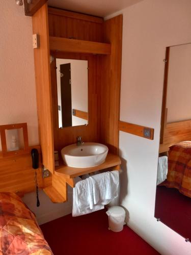 a bathroom with a sink and a mirror at Le Motel Saint Martin in Verneuil d'Avre et d'Iton