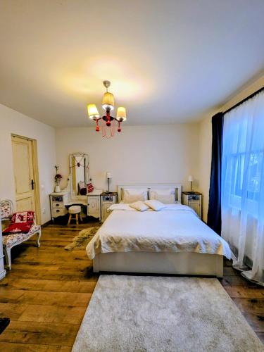 a bedroom with a bed and a chandelier at Casa De Gallois in Sinaia