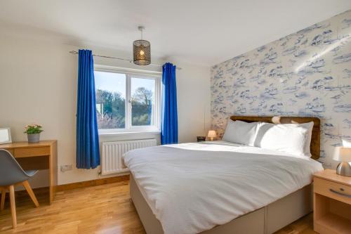a bedroom with a bed and blue wallpaper at 2 Bed in Newton oc-bow124 in Porthcawl