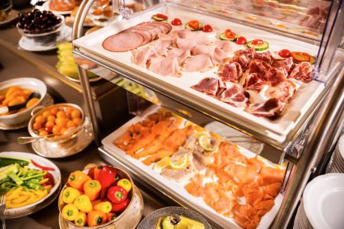 a buffet filled with lots of different types of food at Hotel Bristol Salzburg in Salzburg
