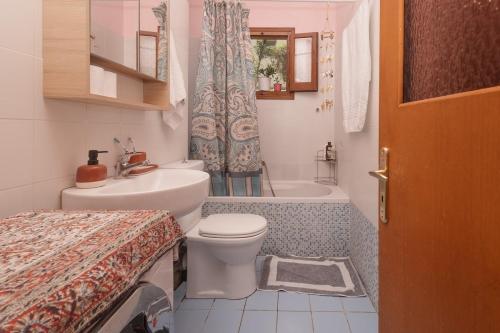 a bathroom with a toilet and a sink and a shower at Casa Dentraki in Corfu