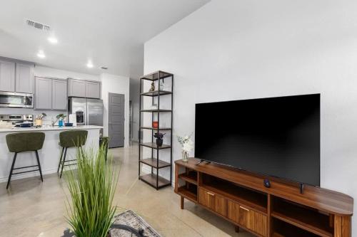 a living room with a large flat screen tv on a wall at NEW Temple 12 BD Contractor & Group Friendly in Temple