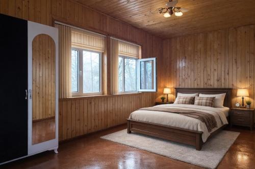 a bedroom with a bed with wooden walls and windows at Colorato Quba in Qırmızı Qǝsǝbǝ