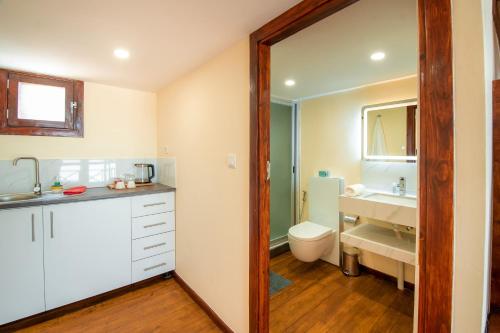 a bathroom with a sink and a toilet at Complexo Palmeiras Bilene in Vila Praia Do Bilene