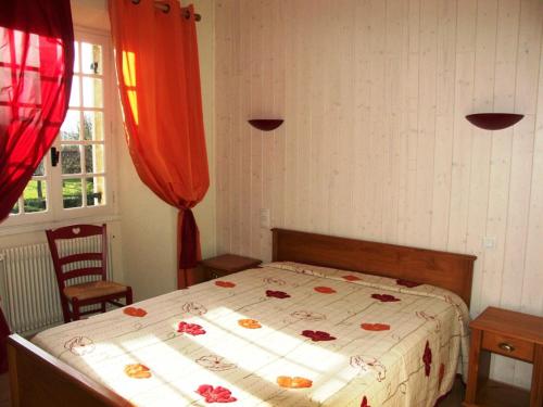a bedroom with a bed with flowers on it at Le Logis du Port in Domme