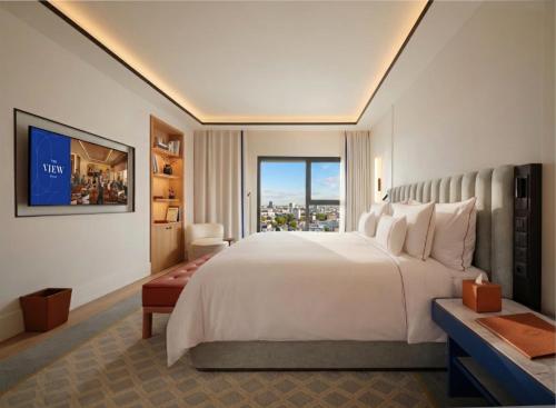 a bedroom with a large white bed and a window at The View Rabat in Rabat