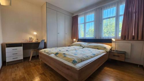 a bedroom with a bed and a desk and window at Marienburg Castle in Wikon