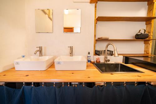 a kitchen counter with two sinks on a counter at 長浜ゲストハウスミカタ Guest House Mikata in Nagahama