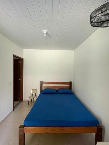 a bedroom with a blue bed in a room at Lago Camping Sana in Macaé