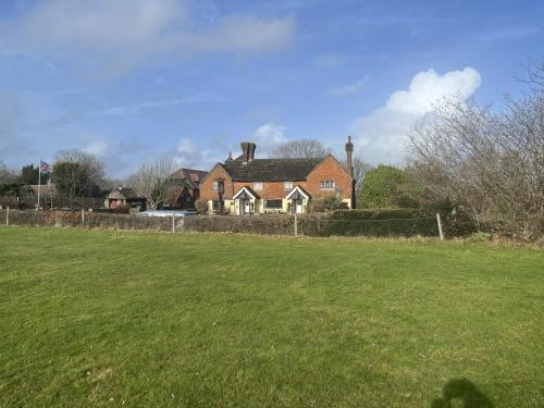 a house in a field with a green field at The Punchbowl Inn in Dorking
