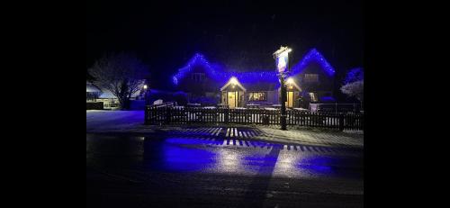a house lit up at night with blue lights at The Punchbowl Inn in Dorking