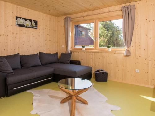 a living room with a couch and a table at Saunaloft Schwarzwald - privater 45qm Saunabereich - großzügige Räume mit viel Ruhe in Gemeinde Aichhalden