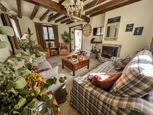 a living room with couches and a fireplace at Casa Rural Tío Conejo in San Román de Cameros