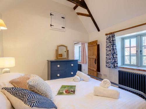 a bedroom with a bed with towels on it at 1 Bed in Holt oc-78233 in Cley next the Sea