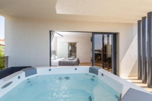 a bath tub in a room with a bedroom at Villa Bellavista in Medulin