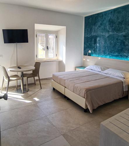 a bedroom with a bed and a table and a dining room at Borgo Marchetti in Camerano