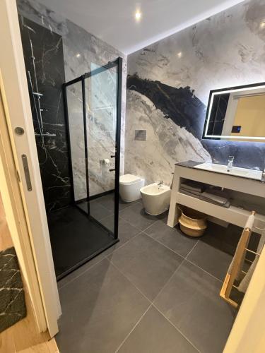 a bathroom with a shower and a toilet and a sink at Casa Lo Bianco in Terrasini