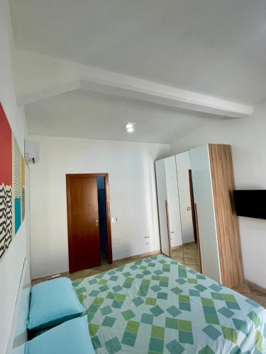 an empty room with a bed and a closet at Casa IXI in Santadi