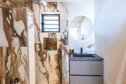 a bathroom with a sink and a mirror at Villa El Rincon 637 - Coral Estate in Willibrordus