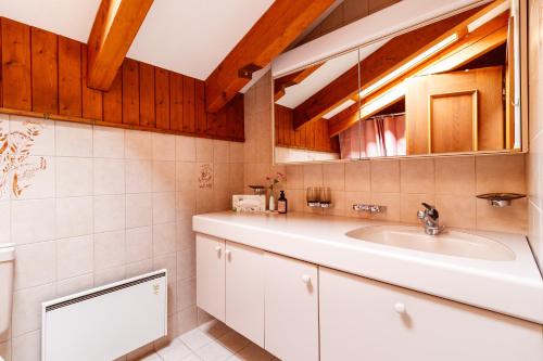 a bathroom with a sink and a mirror at Ferienhaus Grundschera Engadin in Brail