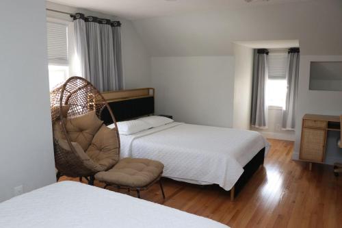 a bedroom with a bed and a chair and a bed at An Apartment for You to Relax - B in Uniondale