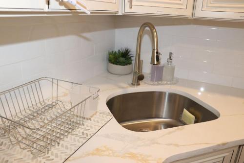 a kitchen counter with a sink in a kitchen at An Apartment for You to Relax - B in Uniondale