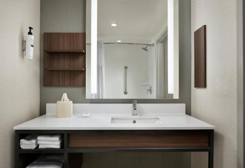 a bathroom with a sink and a mirror at Hilton Garden Inn Jackson-Madison in Madison