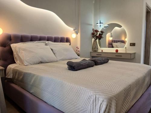 a bedroom with a large bed with two pillows on it at Olympian Gods apartments in Alikanas