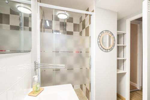 a bathroom with a shower with a glass door at Le Petit Vals - Proche Casino in Vals-les-Bains