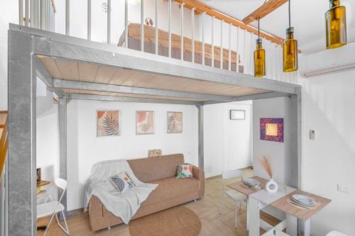 a living room with a couch and a loft at New Apartment Piombino wifi parking in Piombino
