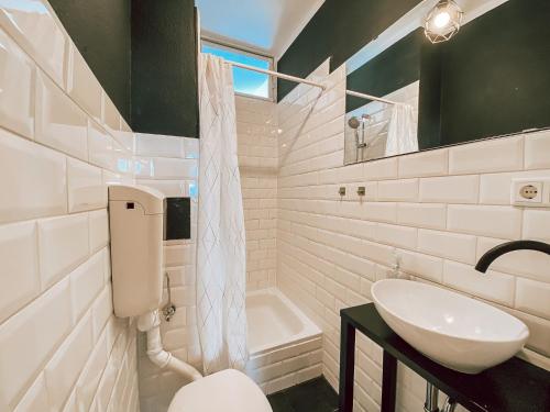 a bathroom with a sink and a toilet and a tub at BetterBeds City - Apartments - Zentral - Smart TV - Küche - WLAN in Brandenburg an der Havel