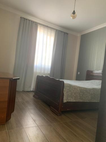 a bedroom with a bed and a large window at Skyview House Tbilisi in Tbilisi City