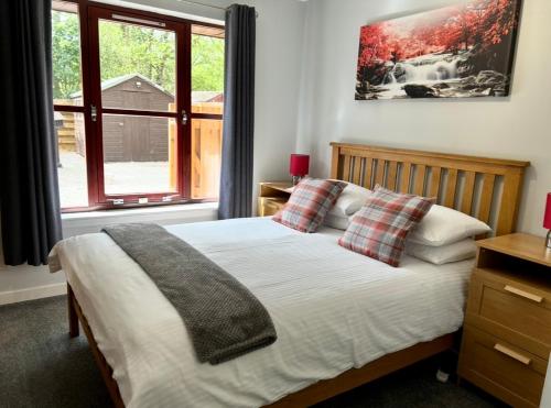 a bedroom with a bed and a window at Rendezvous , Aviemore in Aviemore