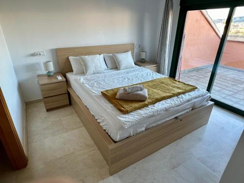 a bedroom with a bed with a towel on it at BiBi House in Jávea