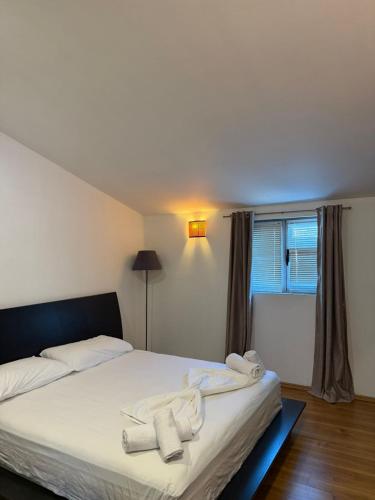a bedroom with a bed with towels on it at Hotel La Cita in Tirana