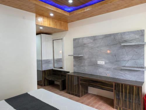 a bedroom with a large stone wall and a bed at Deodar hill top home stay chail in Chail