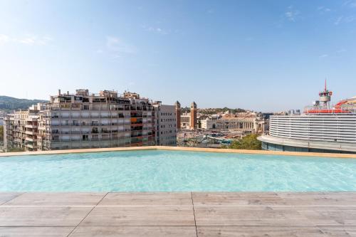 a large swimming pool on the roof of a building at B Hotel in Barcelona