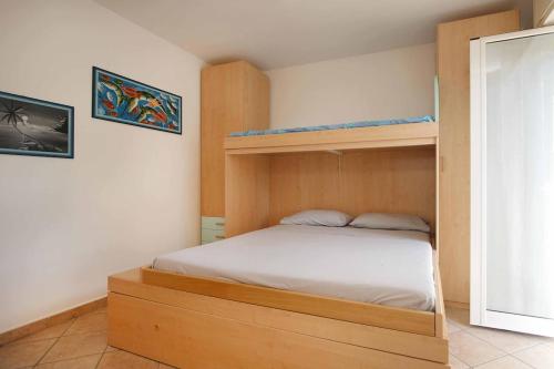 a bedroom with a bunk bed with white sheets at WI-RO Cavour, 48 - Tra Cielo e Mare in Marina di Andora